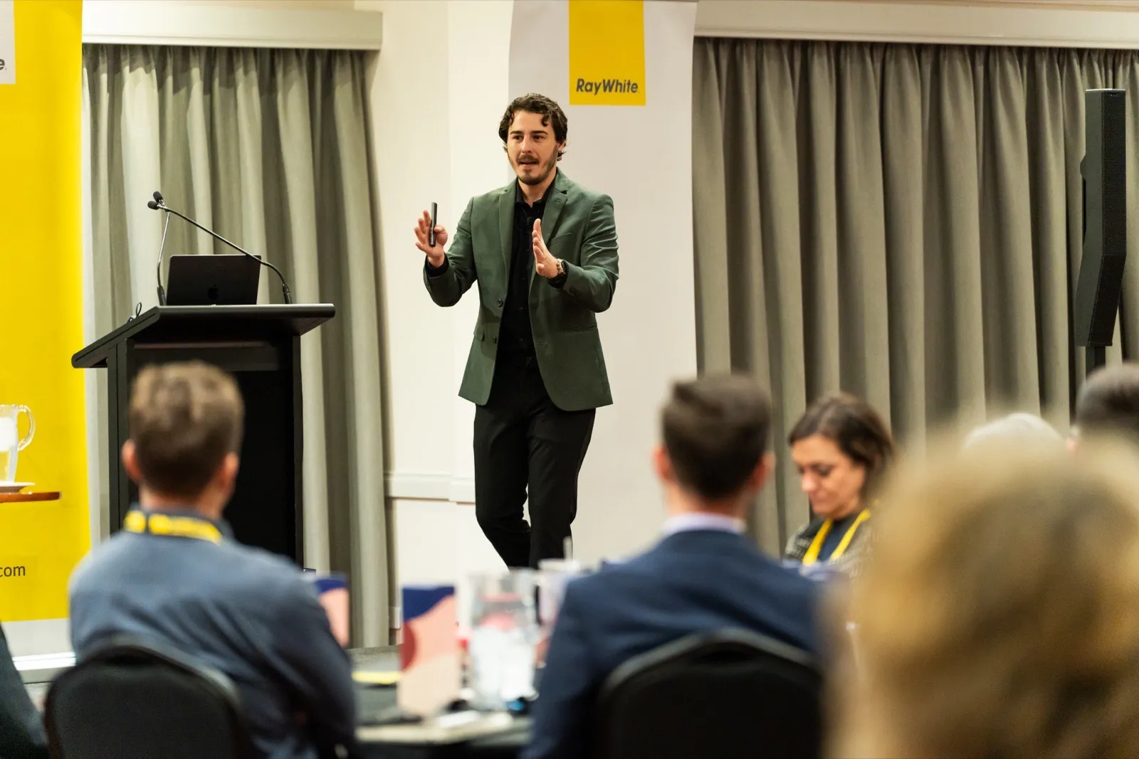 Joe Shannon presenting on stage at the Ray White PM Propel 2026 conference in Busselton