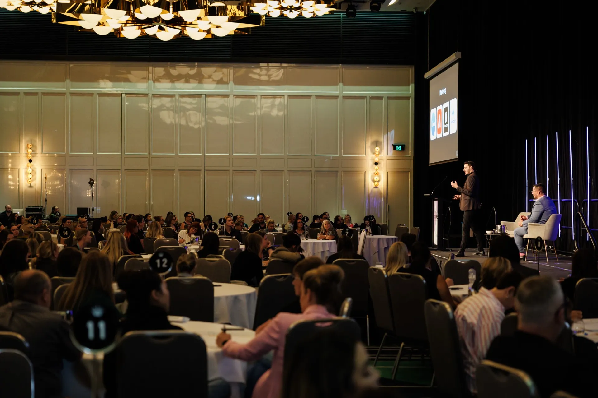 Joe Shannon presenting on stage at a REIWA industry event